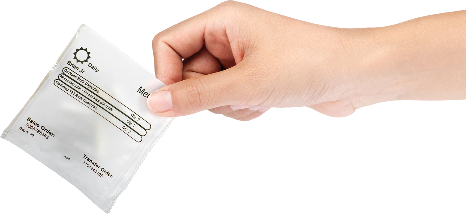 A hand holding a MedPax daily dose packet